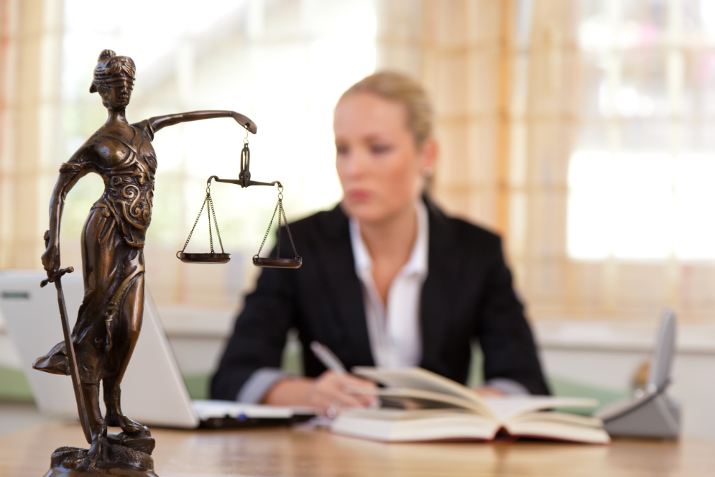 Attorney at desk with scales of justice